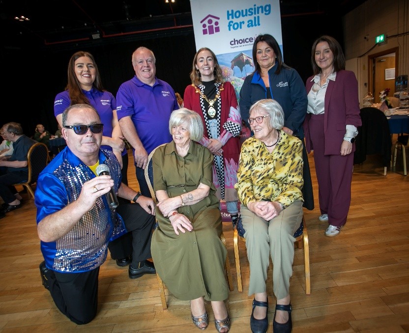 Group of mixed age people posing for a photo in the Millennium Forum