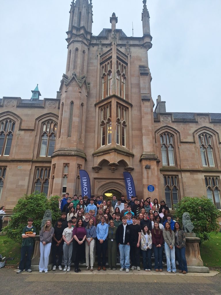 A group of students and teachers outside of a university building